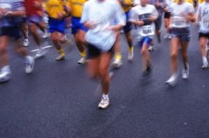 MARATHON RUNNERS RUNNING ON BLACK PAVEMENT