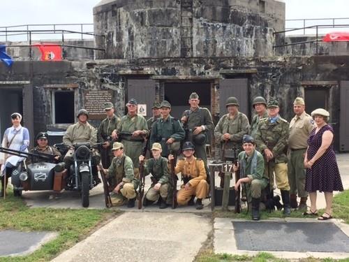 GROUP OF PEOPLE POSING IN FRONT OF  BUILDING